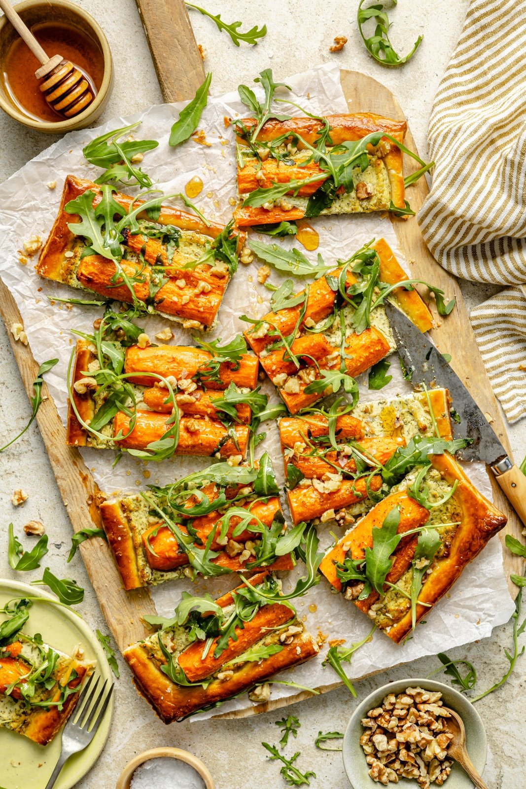 roasted carrot tart sliced on a cutting board