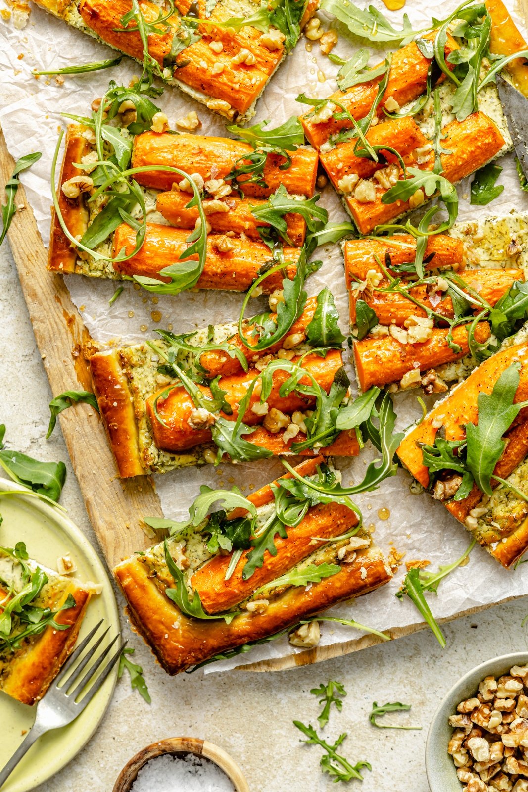 roasted carrot tart sliced on a cutting board