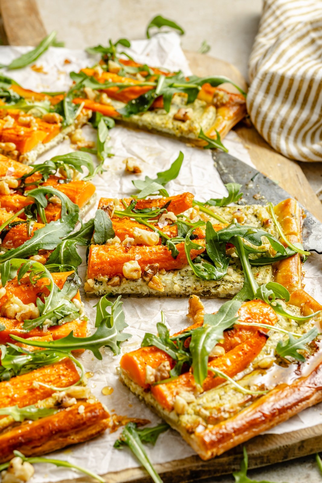 slices of a roasted carrot tart on a cutting board