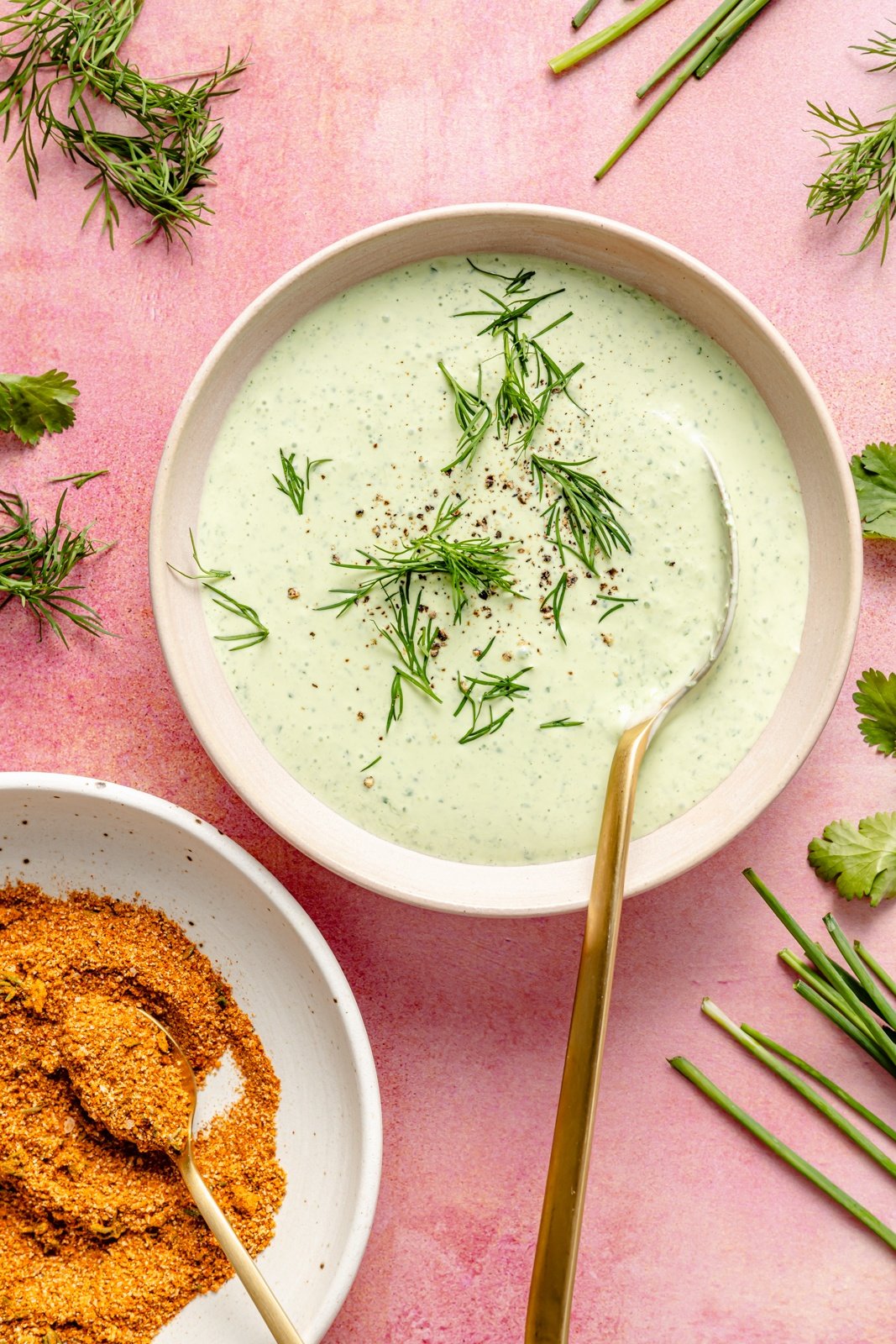 herby yogurt sauce in a bowl to drizzle onto sheet pan salmon