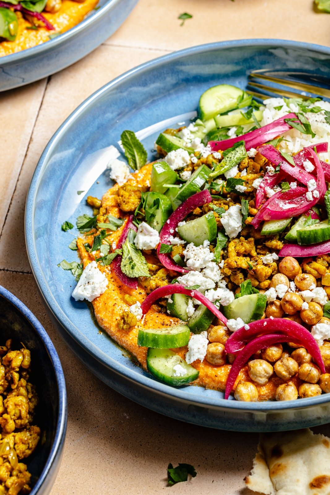 Mediterranean spiced chicken bowl with herbs, chickpeas, and veggies