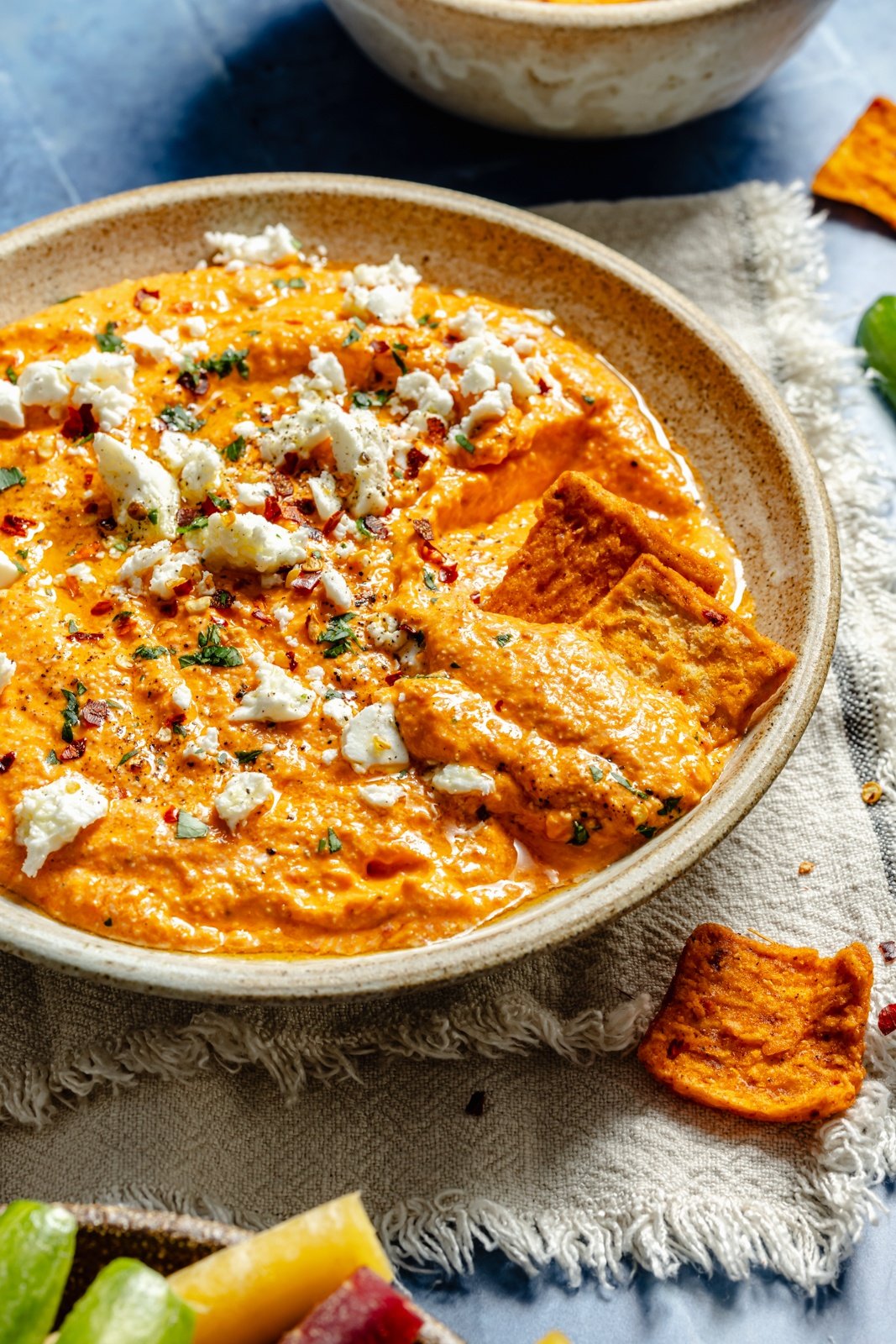 roasted red pepper dip in a bowl with pita chips