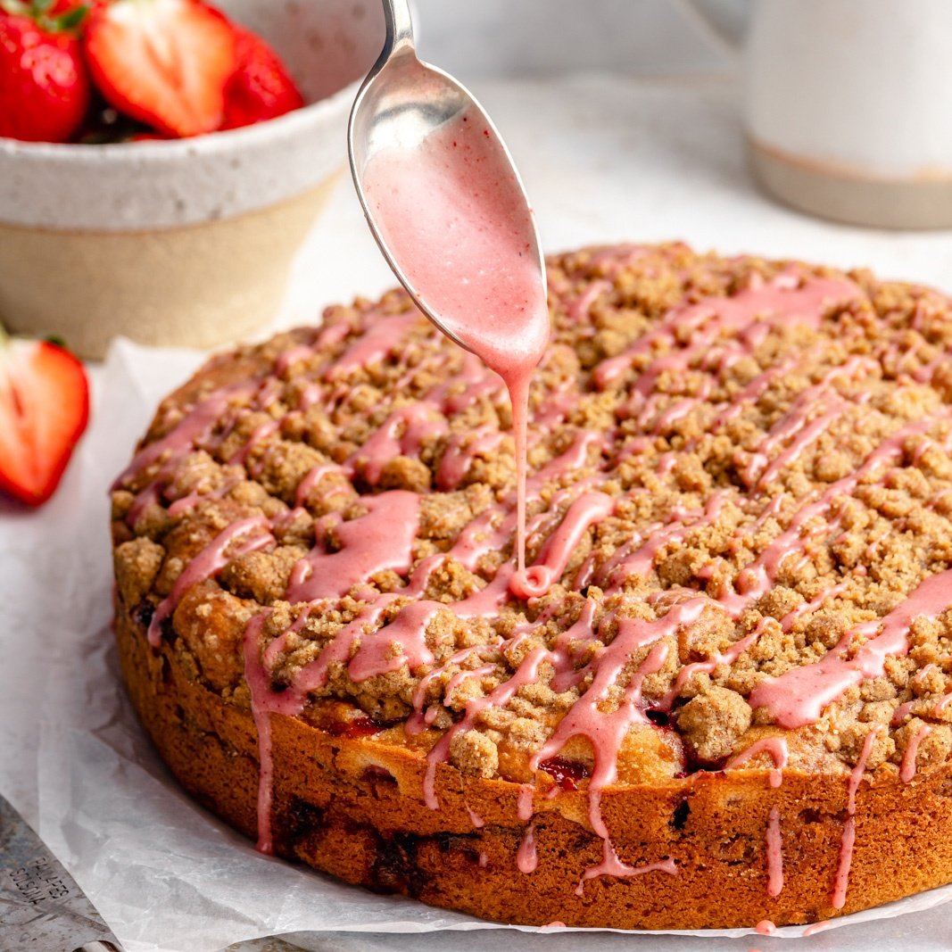 drizzling strawberry coffee cake with a strawberry glaze