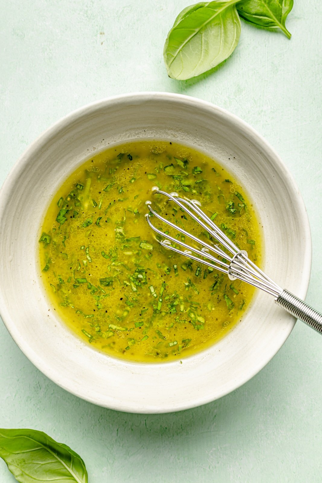 mixing dressing for a vegetarian spring green salad