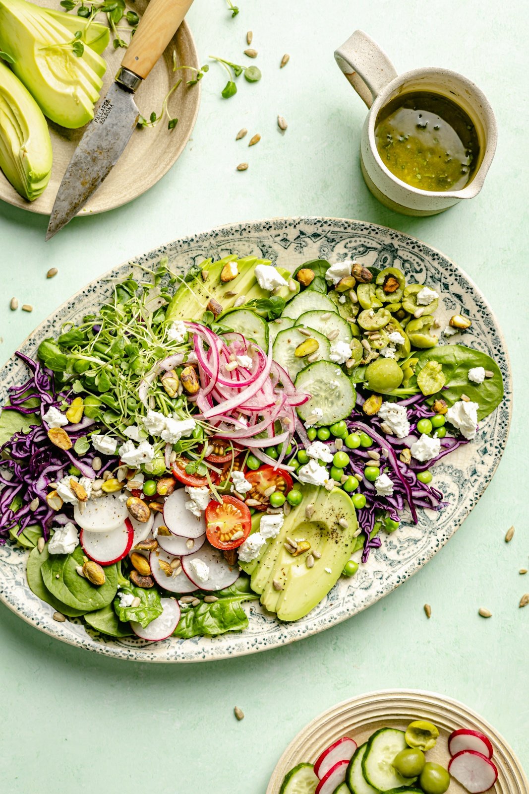 easy spring green salad with avocado on a platter