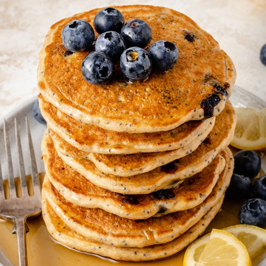 stack of lemon poppy seed pancakes with blueberries