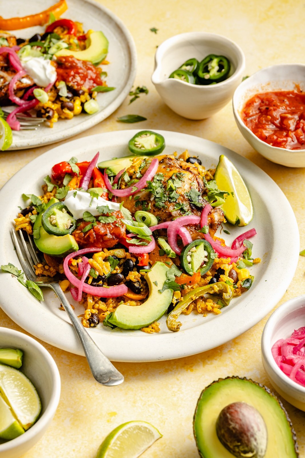 one pan fajita chicken and rice on a plate with garnishes