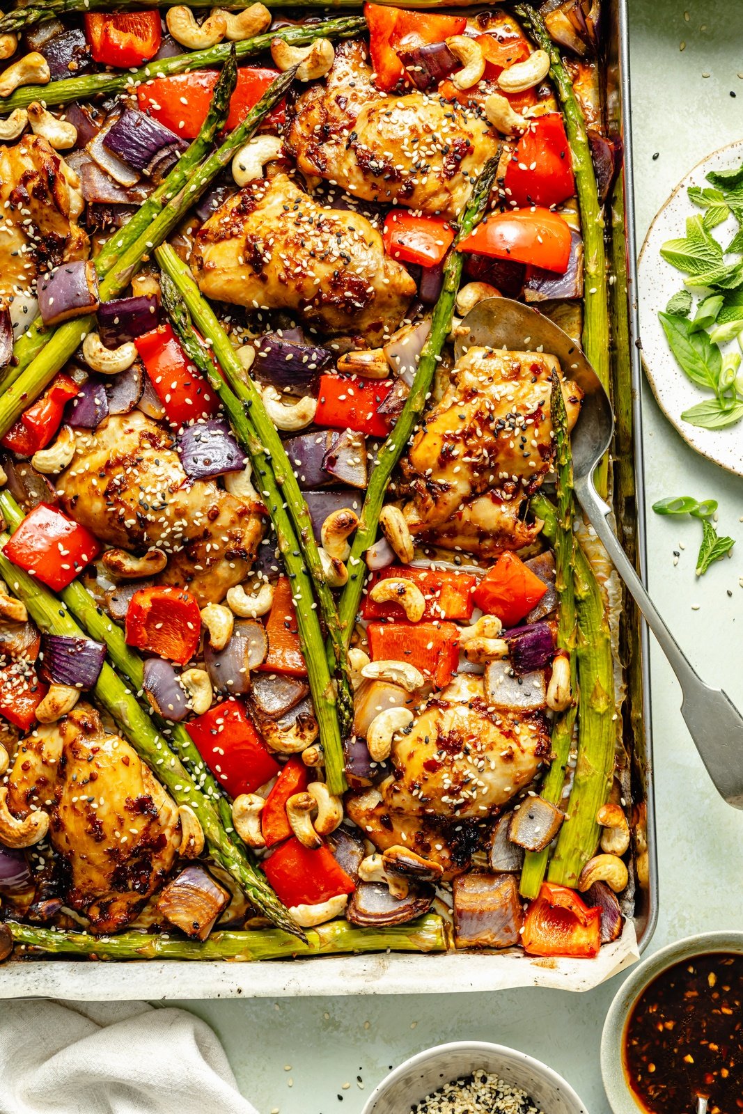 sheet pan sesame chicken and asparagus baked on a pan