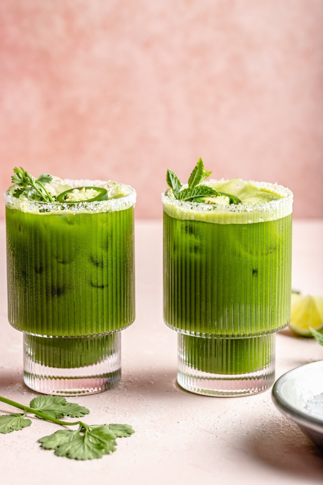 two green margaritas in glasses