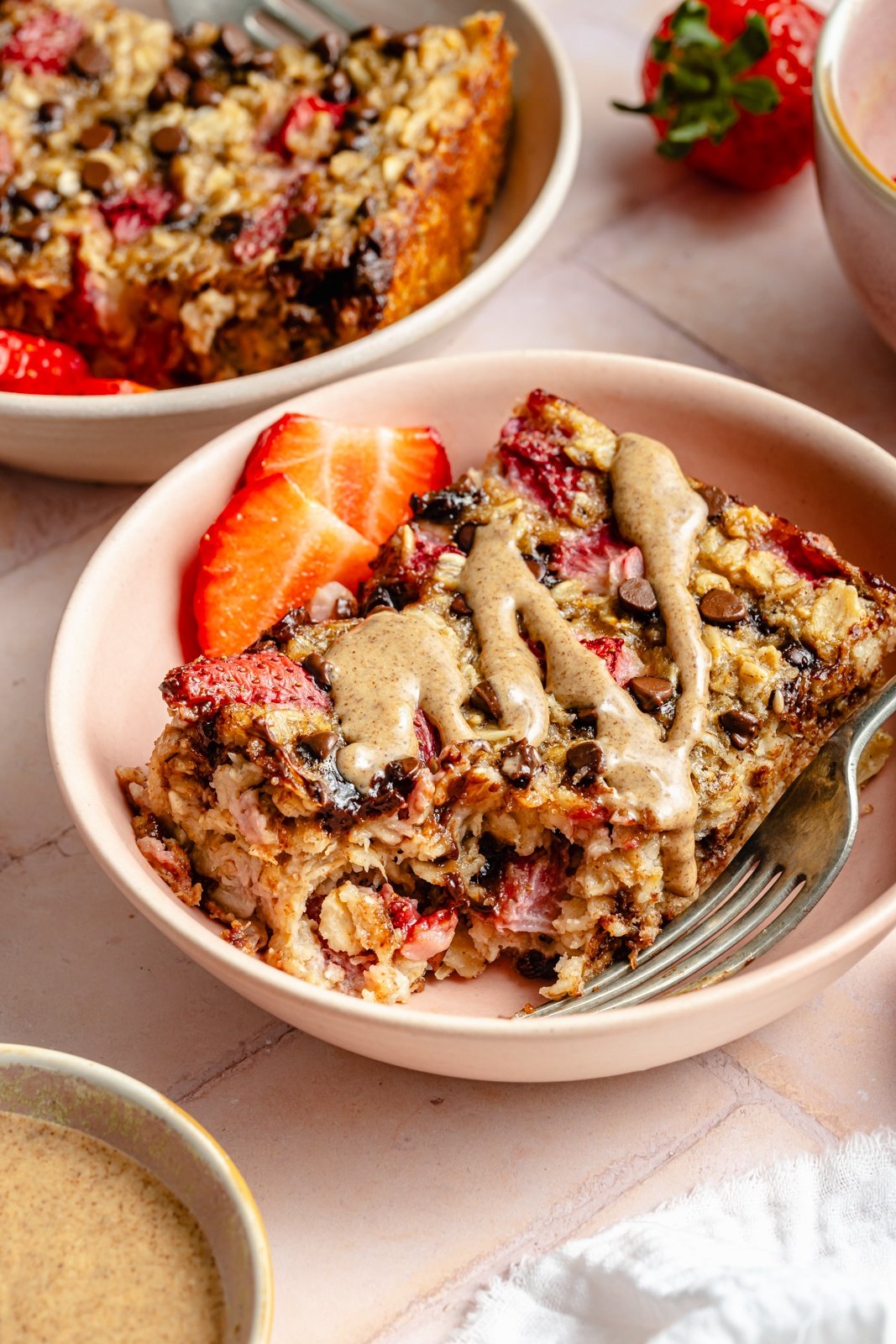 slice of strawberry banana baked oatmeal in a bowl