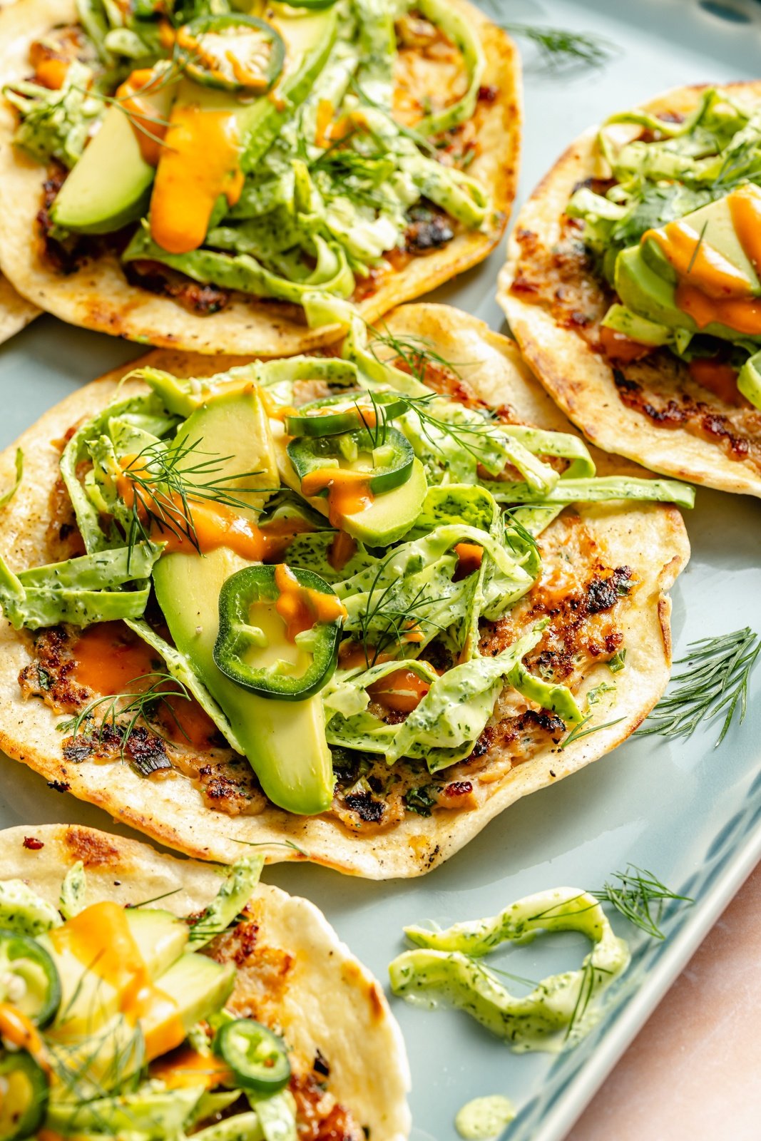 buffalo chicken smash taco topped with slaw and avocado