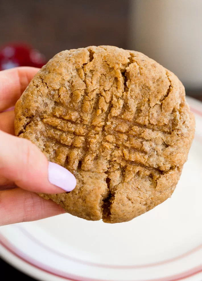 Holding a homemade peanut butter cookie in hand