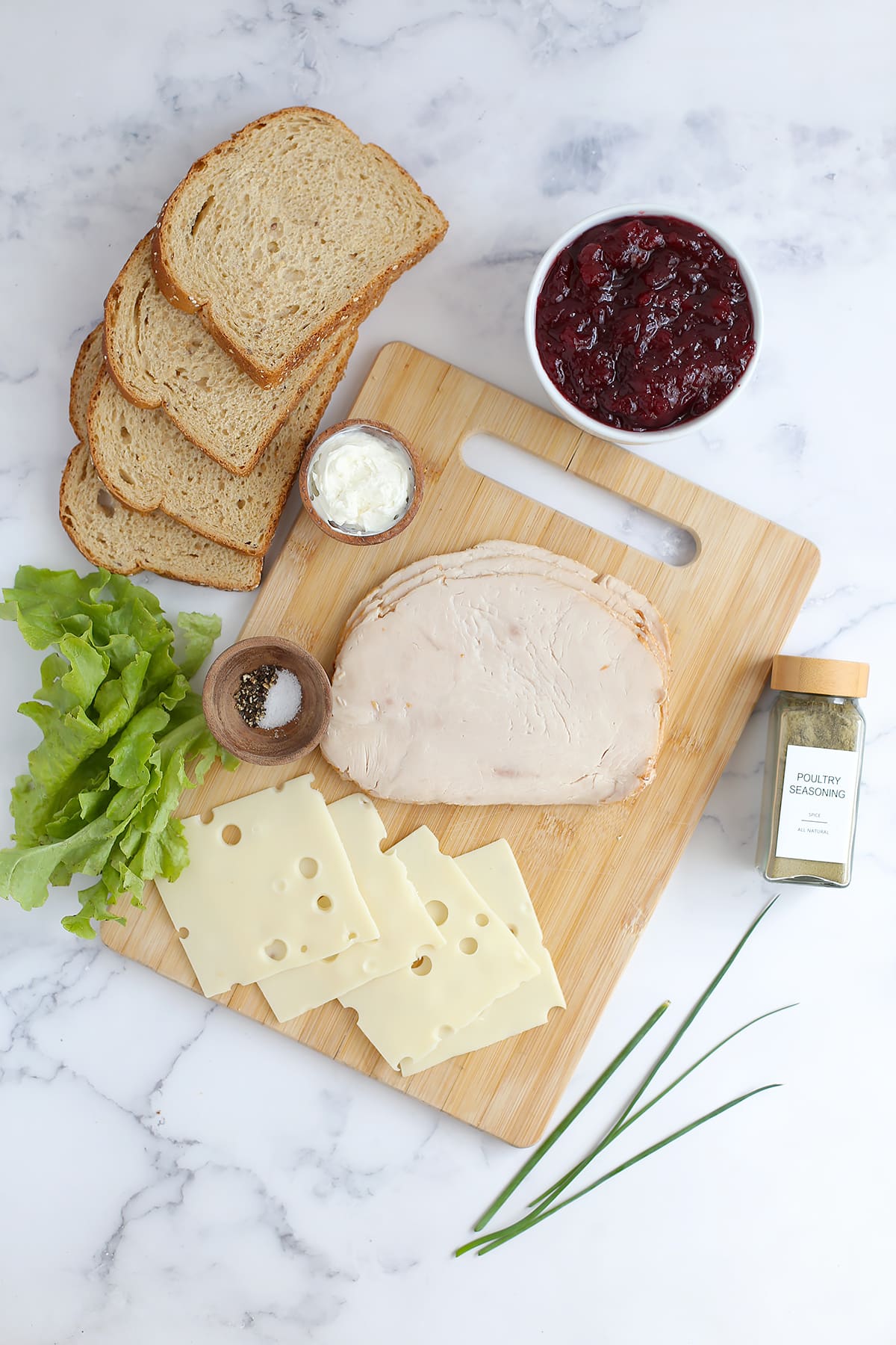 Ingredients needed to make cranberry turkey sandwiches on whole wheat bread. 